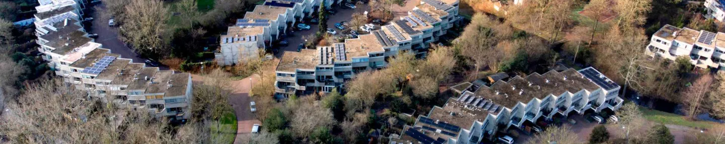 Luchtopname van de Leusdense proeftuinwijk Rozendaal, met in halve cirkels gebouwde drive-in-woningen omringd door groen